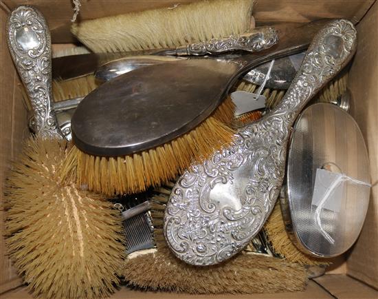 A set of three silver-mounted glass dressing case fitments, pair of brushes, various silver-mounted dressing table sets, etc.